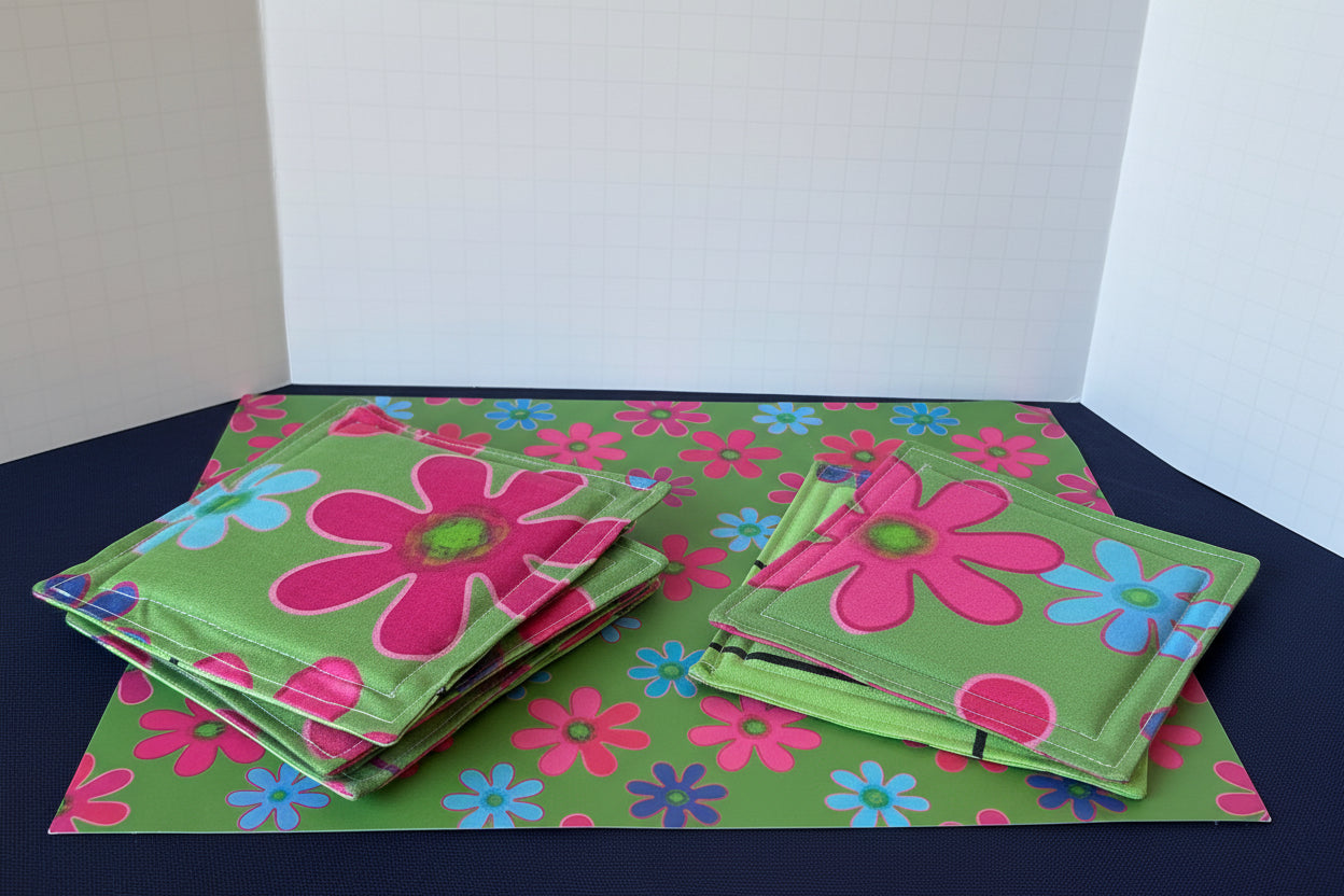 Floral coasters with a glass drink container on a matching mat.