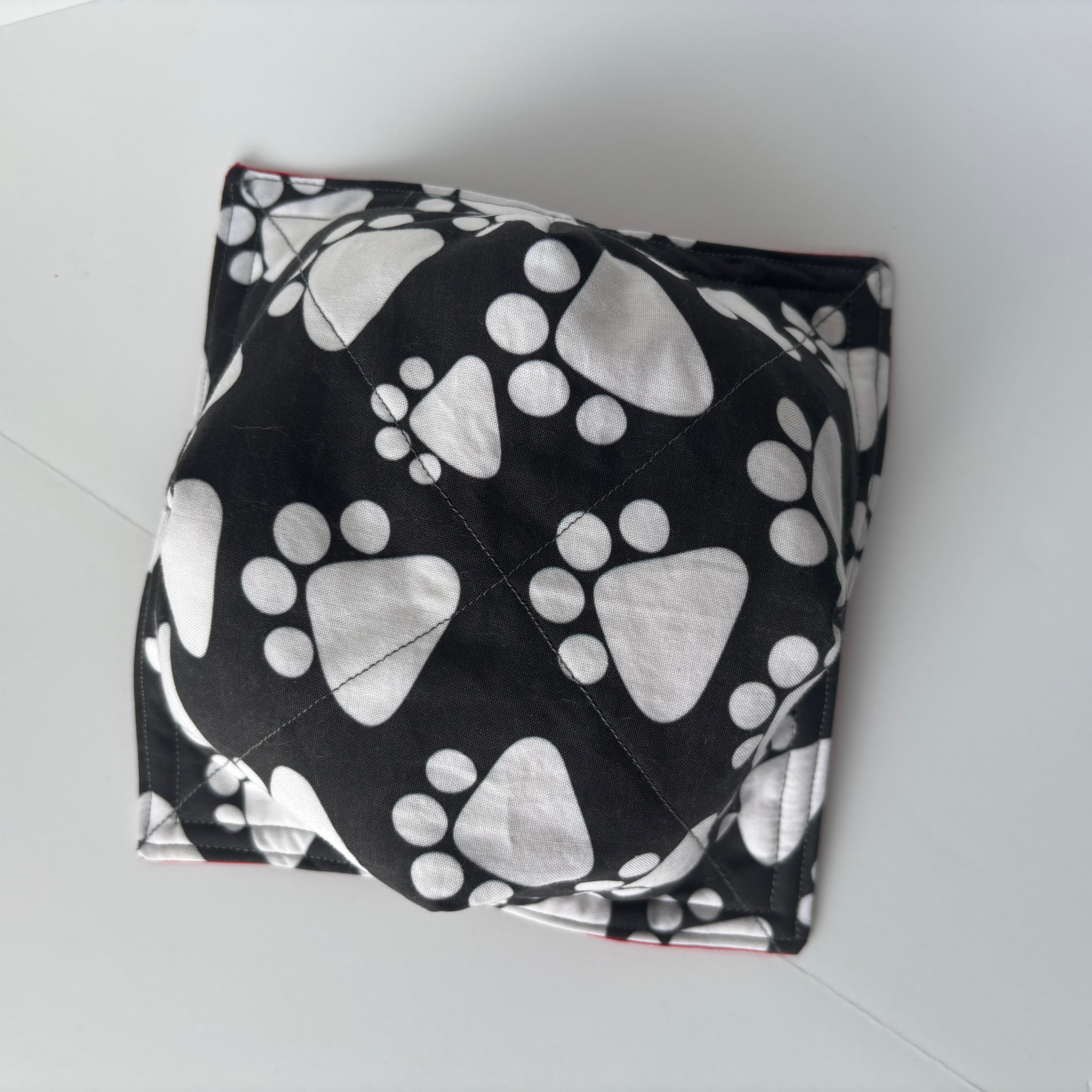 bottom of fabric cozy bowl black and while paw print pattern.