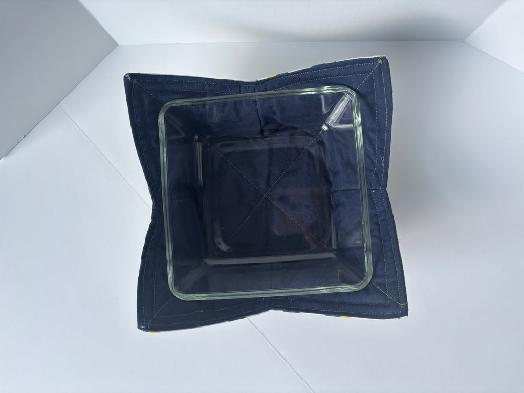 Navy blue inside of cozy bowl with clear glass dish inside. 