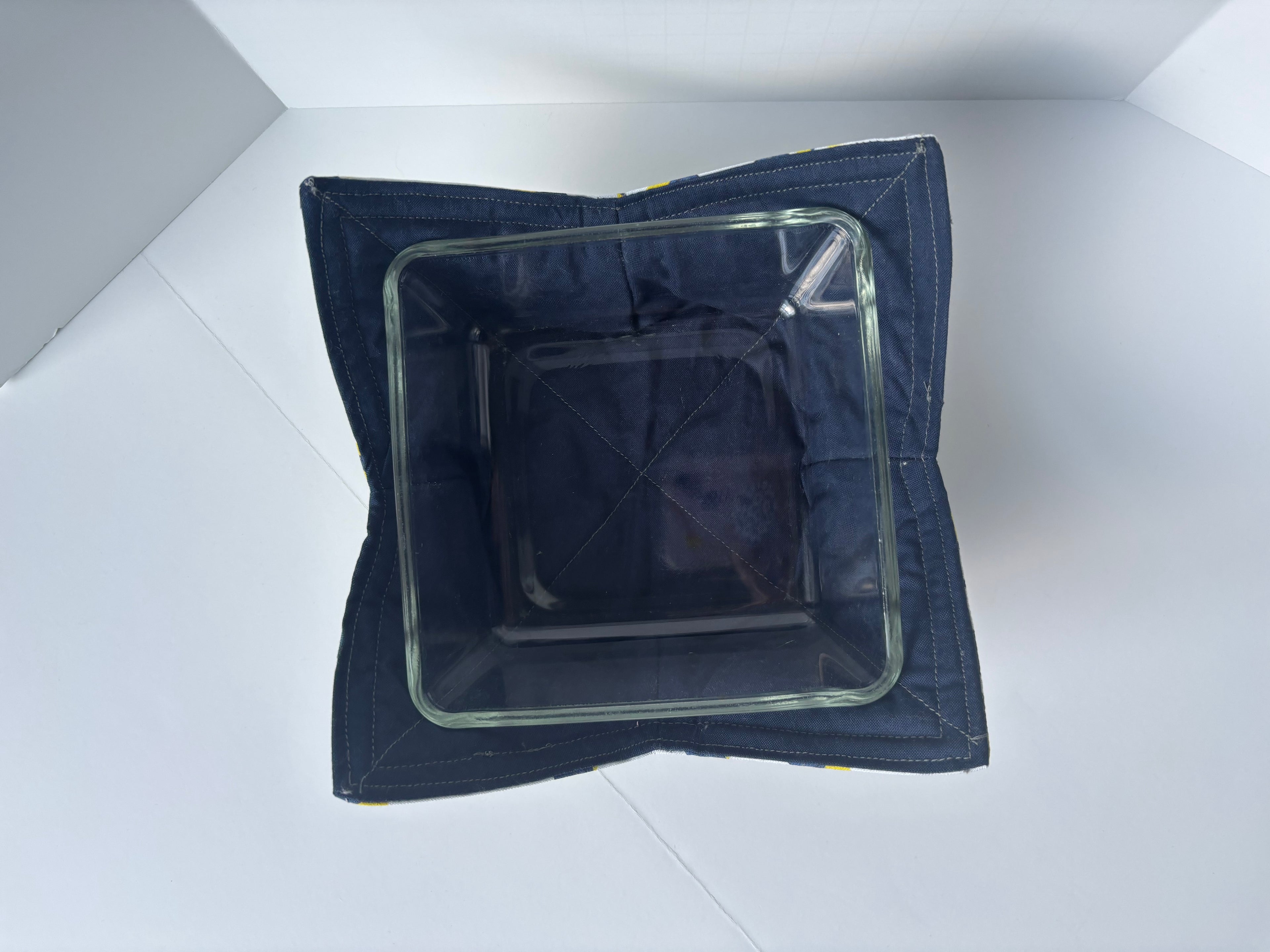 Navy blue inside of cozy bowl with clear glass dish inside. 