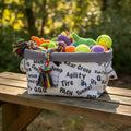 A fabric storage basket with a gray interior and a white exterior printed with black automotive terms like 'MACH', 'Tire', 'Jump', and 'Agility'.